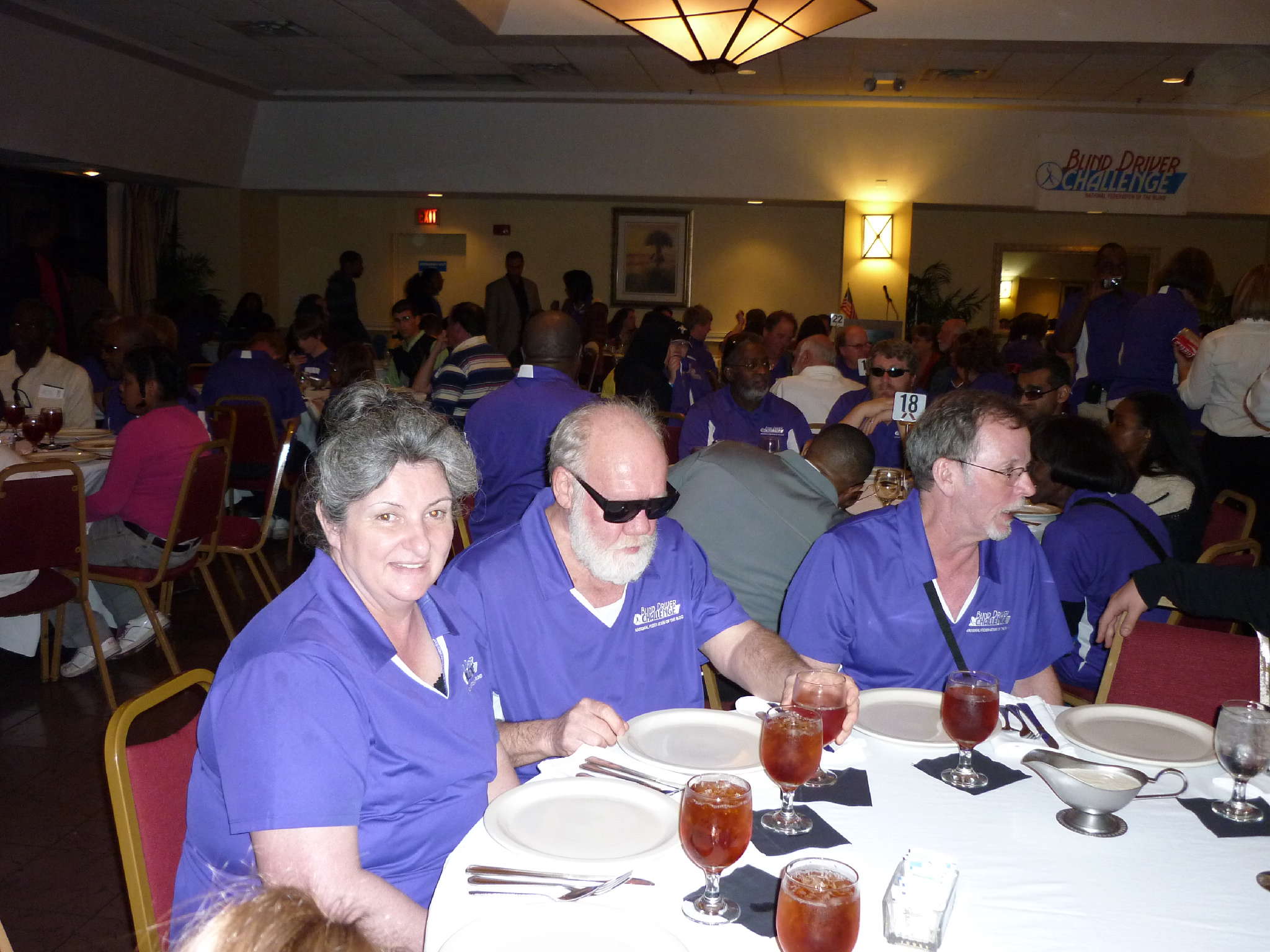 Pamela and John Glisson sitting down at banquet