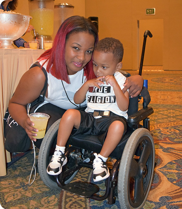 Mom bends down to pose for a picture with her young son.